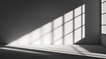Obraz premium Sunlight streams through industrial window in empty room, casting shadows