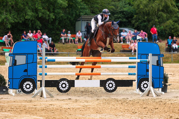 Horses Jumping horse with rider in a jumping competition, in the course.