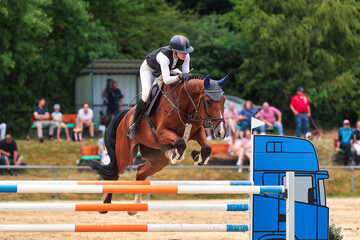 Horses Jumping horse with rider in a jumping competition, in the course.
