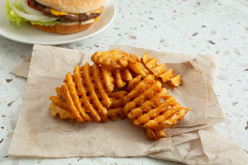 A view of a pile of waffle fries.