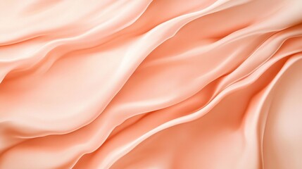 Obraz premium Soft peach silk fabric with elegant folds and gentle waves, perfect for backgrounds.