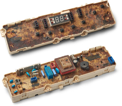 severely corroded and damaged control panel of washing machine isolated white background, display module, touch control and electronic components visible with dirty glue like conformal coating
