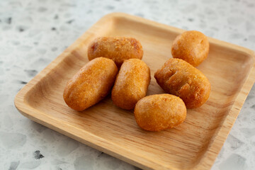 A view of a plate of mini corn dogs.