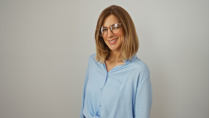 Woman smiling isolated over white background wearing glasses and blue shirt, showcasing attractive blonde caucasian female in an adult portrait