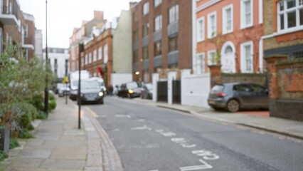 Blurred view of a london street in winter with bokeh effects showcasing urban architecture, defocused cars, and the characteristic charm of chelsea, united kingdom.