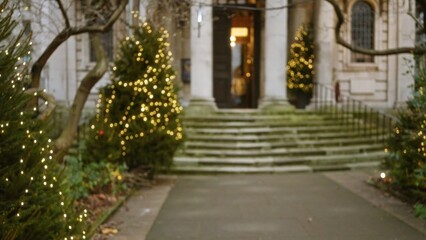 Fototapeta premium Blurry view of a london street adorned with christmas lights and decorations, capturing a festive winter atmosphere with bokeh effect amidst historical architecture.