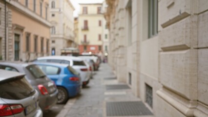 Blurred evening view of a quiet rome street with defocused historic buildings and parked cars, capturing the essence of italy's urban night life.