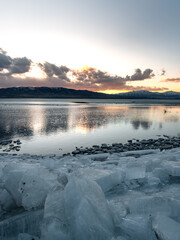 Ice stacks on Utah Lake during blue hour.