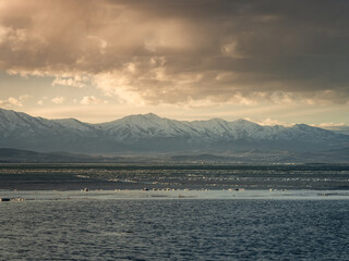 Mountains at sunset at Vineyard Beach on Utah Lake in Utah at sunset in February 2025.