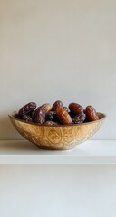 Dates in wooden bowl, shelf, simple background, healthy snack