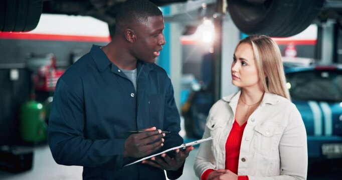 Woman, mechanic and talking on tablet at garage of car repairs, vehicle inspection and maintenance. Artisan, client and digital with diagnostic software for service manual, ordering parts and updates