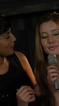 Happy friends singing songs together in bar