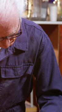 Shoemaker marking a piece of leather with pencil