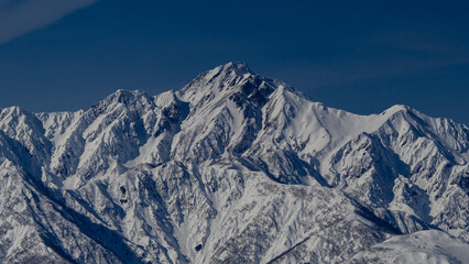 晴天の空と雪の北アルプス　長野県白馬村