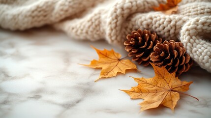 Enjoy the cozy autumn atmosphere at home. a warm patchy blanket, maple leaves, pinecones, and ample space for text or adverts on a beige isolated background.