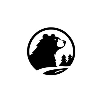 A stylized bear logo in a circle. Silhouette of a black bear's head with mountains and two trees.