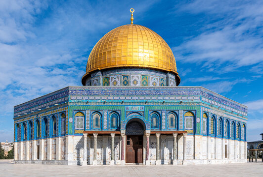 The Dome of the Rock, the sacred Al Aqsa Mosque with a dark blue sky and scattered clouds on Jerusalem's Temple Mount