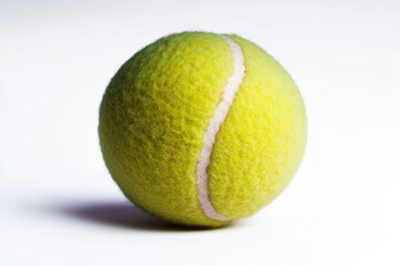 A close-up shot of a tennis ball on a white surface, perfect for sports-related or graphic design use