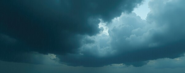 Obraz premium Dark grey rain clouds hovering above a gloomy sky, dark grey, rain