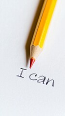 Writing the phrase 'I can' with a yellow pencil, slightly tilted, symbolizes determination and growth while highlighting the act of revision with red lead on white paper