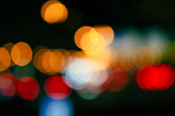 blurred background of night city and roads orange red and blue side lights and roads. High quality photo