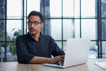 Fototapeta premium Business Professional Working at Office Desk Using Laptop