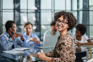 business woman with executives working in background