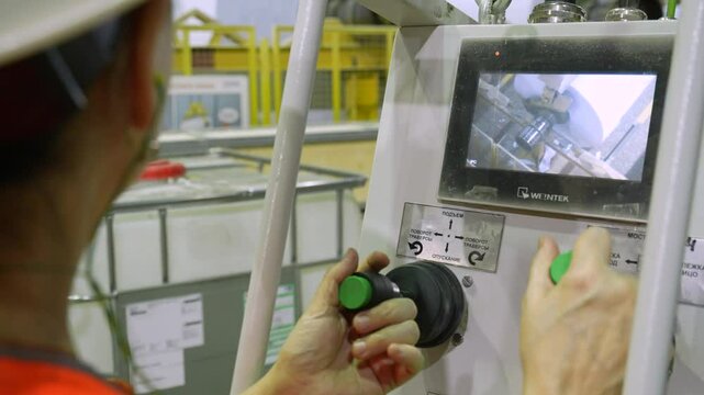 The crane operator unloads the finished paper in a roll from the paper machine. Paper production.
