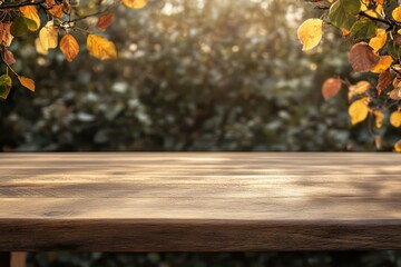 An empty wooden table with colorful autumn foliage framing the edges and a soft golden sunset glow in the background.
