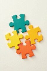 Obraz premium Colorful Interlocking Puzzle Pieces on a Light Background Representing Teamwork and Problem Solving