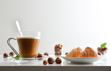 Coffee with hazelnut drink and pastries with white isolated background