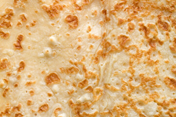 Texture of homemade pancake. Close-up of flour pastries. Fresh fried pancake.