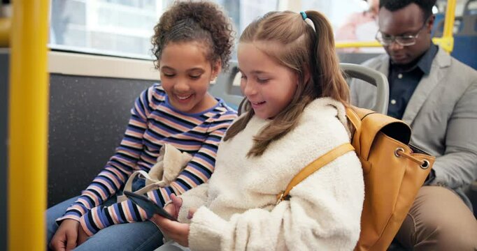 Cellphone, playing and children on bus for travel together with educational game online for learning. Happy, phone and girl students commute with public transport to school looking at class schedule.