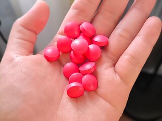 Medicine pills on young woman hand. Healthcare and medical concept. Suicide by overdosing on concept. Pain killer on hand