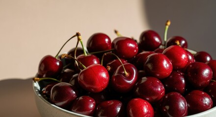 Fresh ripe cherries in bowl with sunlight shadows