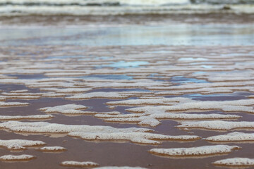 
you can see the foam formed by the waves of the sea.