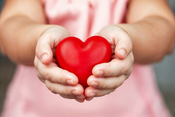 Fototapeta premium Red heart in open hand , A red heart in the hand that conveys emotions of love and tenderness , Generative AI