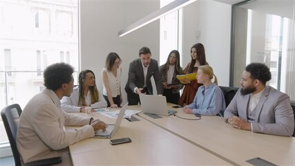 Busy corporate office, diverse business professionals team is discussing financial analysis, reviewing sales reports, brainstorming innovative strategies for success in their operations and projects - Powered by Adobe