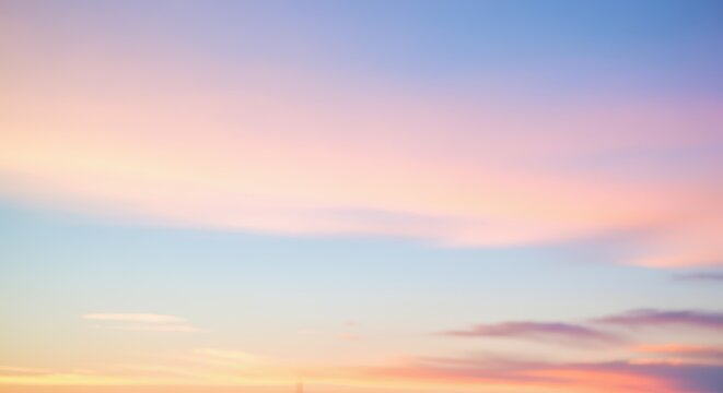Serene sunset sky with pastel pink and blue clouds