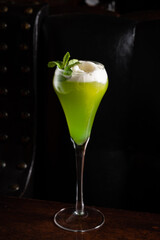 Refreshing Green Cocktail Garnished With Mint Leaves Served in an Elegant Glass, Showcasing Vibrant...