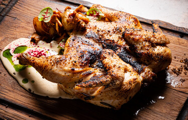 Savory Roasted Chicken Served on a Rustic Wooden Platter With Flavorful Accompaniments, Showcasing Culinary Artistry in a Warm Dining Atmosphere
