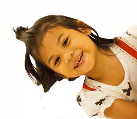 Joyful peekaboo moment child's face and smile captured in bright studio environment