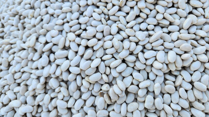 Dry white beans, frequently used in Turkish cuisine, are key ingredients in various homemade dishes and salads such as piyaz, adding protein and flavor to these traditional meals.
