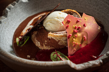 Delightful Chocolate Dessert Creation Served on a Rustic Plate, Garnished With Fresh Ingredients and Accompanied by a Scoop of Velvety Ice Cream