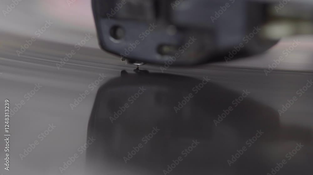 Poster macro close-up of a record player needle in action, capturing the delicate moment of contact with th