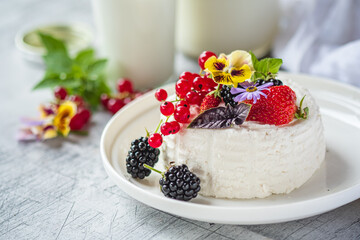 Delightful Dessert Adorned With Fresh Berries and Edible Flowers on a Wooden Table in a Cozy Kitchen Setting, Inviting Summer Vibes and Sweet Indulgence