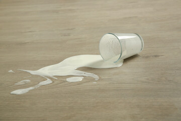 Spilled glass of milk on the floor	