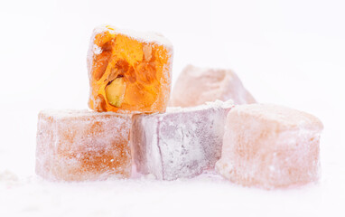 Sweet food Turkish delight, assorted rahat locum in form of cubes with nuts and powdered sugar, traditional food, on white background