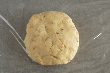 Wrapping the kneaded scone dough in plastic wrap.