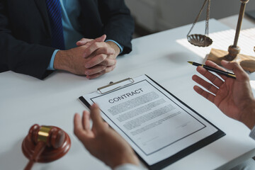 Two lawyers are discussing contract details in a meeting, with a gavel and scales of justice...